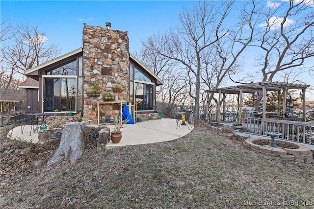 view of yard featuring a patio, a sunroom, and a pergola