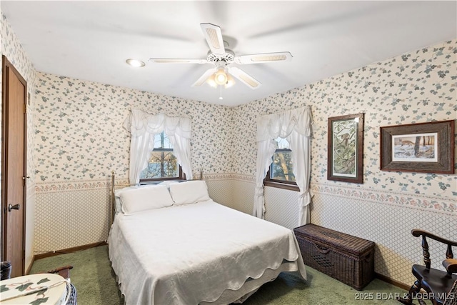 carpeted bedroom featuring wallpapered walls and a ceiling fan