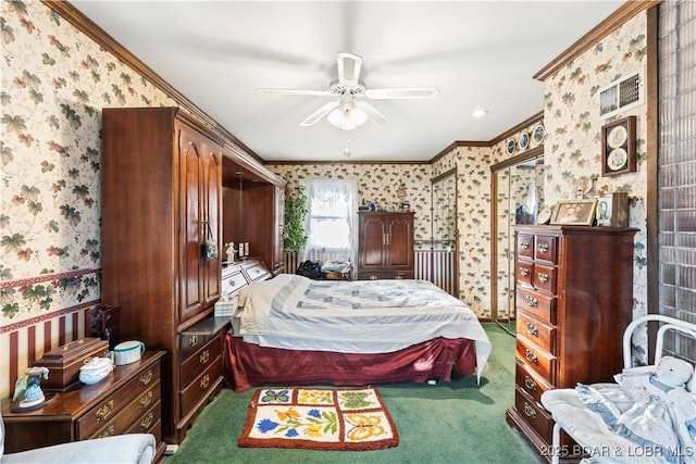 carpeted bedroom with wallpapered walls, a ceiling fan, and ornamental molding