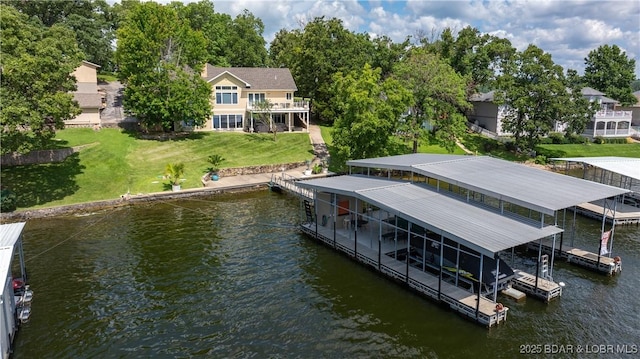 dock area featuring boat lift, a yard, and a water view