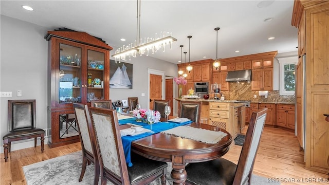 dining room featuring recessed lighting and light wood-type flooring