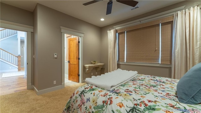 carpeted bedroom with visible vents, ceiling fan, and baseboards