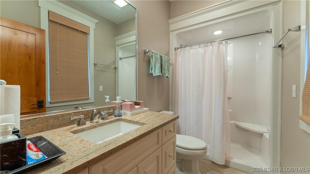 bathroom featuring vanity, toilet, and a shower with shower curtain