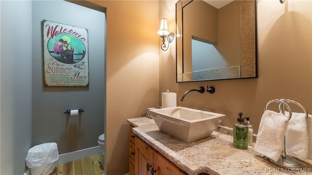 bathroom featuring toilet and vanity