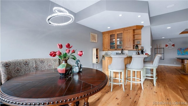 dining area featuring recessed lighting, light wood-style flooring, and baseboards