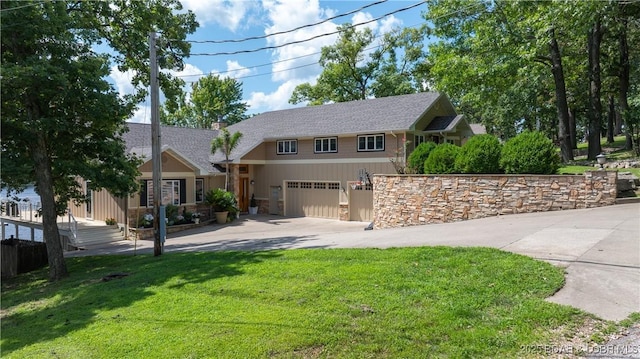 view of front of property with a garage, driveway, and a front lawn