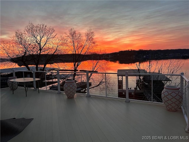 view of patio / terrace with a balcony and a water view