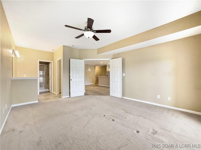 unfurnished bedroom featuring baseboards, light carpet, and a ceiling fan