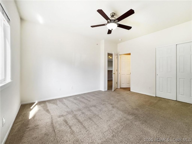 unfurnished bedroom featuring ceiling fan, baseboards, and carpet