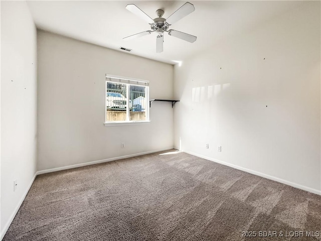 unfurnished room with carpet flooring, baseboards, visible vents, and ceiling fan