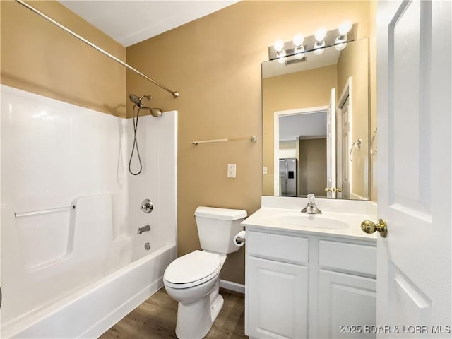 full bathroom with tub / shower combination, toilet, vanity, and wood finished floors