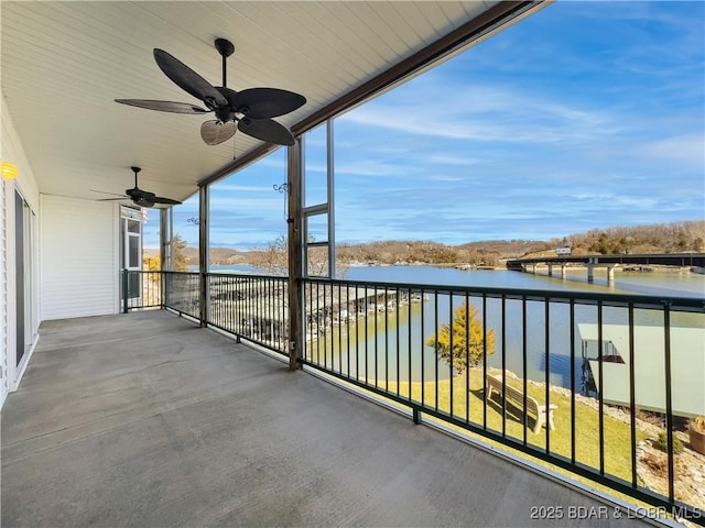 balcony with a water view and ceiling fan