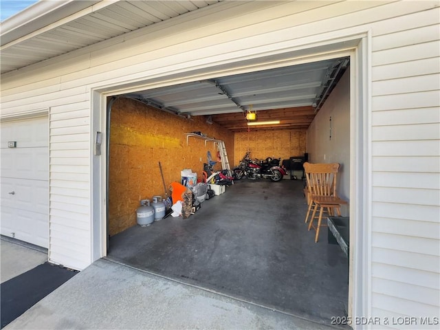 garage with a garage door opener and driveway