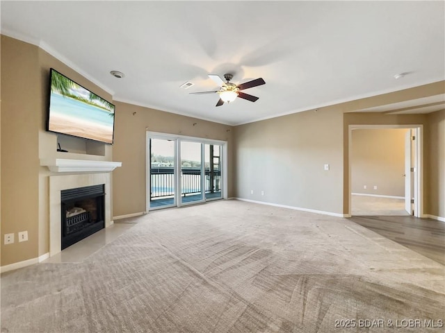 unfurnished living room featuring baseboards, crown molding, a ceiling fan, and a tile fireplace