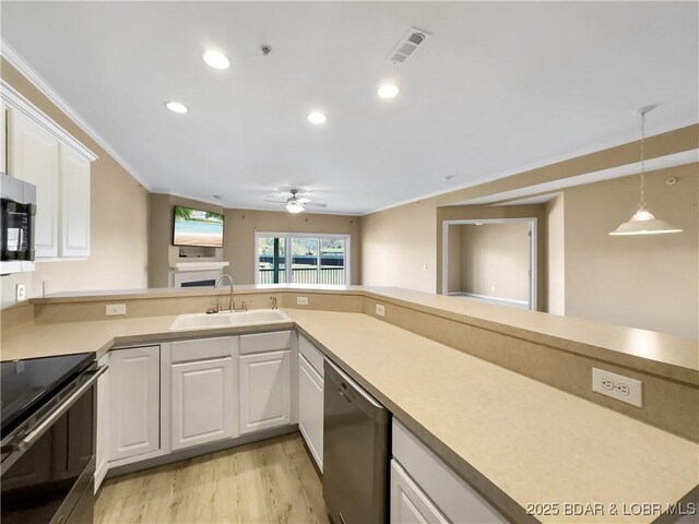 kitchen with visible vents, ceiling fan, appliances with stainless steel finishes, white cabinets, and a sink