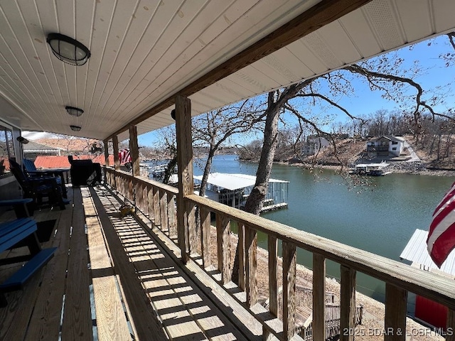 wooden deck featuring a water view