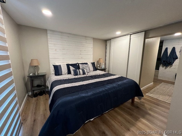 bedroom featuring recessed lighting, baseboards, and wood finished floors