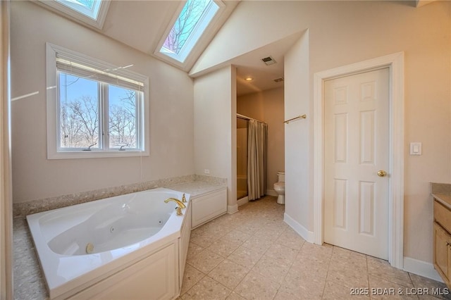 bathroom with vanity, a tub with jets, visible vents, vaulted ceiling with skylight, and curtained shower