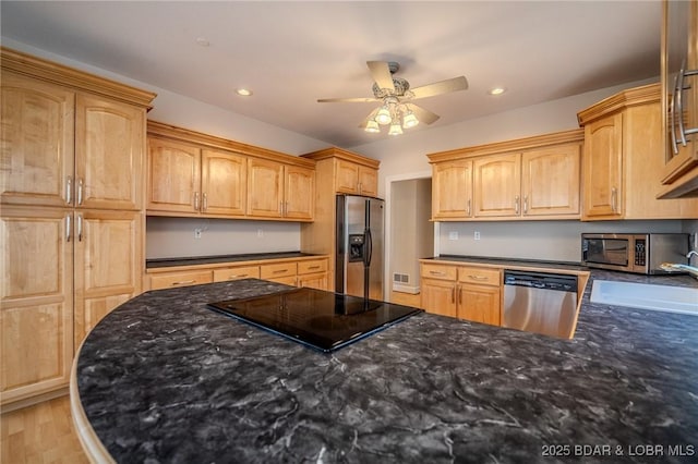 kitchen with a ceiling fan, dark stone countertops, a sink, recessed lighting, and stainless steel appliances