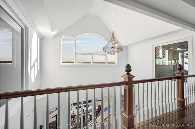 hallway with vaulted ceiling, an upstairs landing, and a chandelier