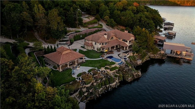 aerial view with a water view and a forest view