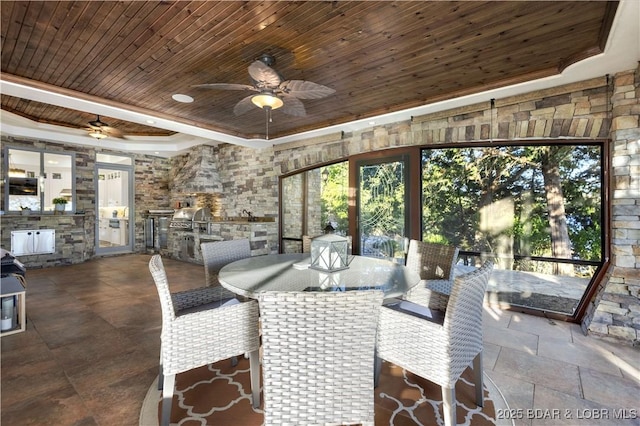 dining room with ceiling fan, wood ceiling, a healthy amount of sunlight, and a tray ceiling