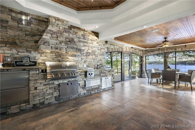 interior space featuring wood ceiling, a ceiling fan, a tray ceiling, and recessed lighting