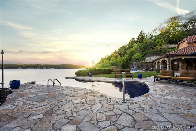 view of patio featuring an outdoor pool and a water view