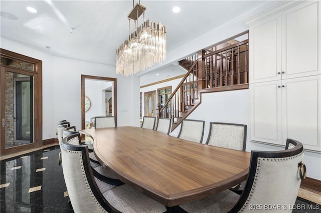 dining area with stairway, baseboards, granite finish floor, recessed lighting, and a notable chandelier