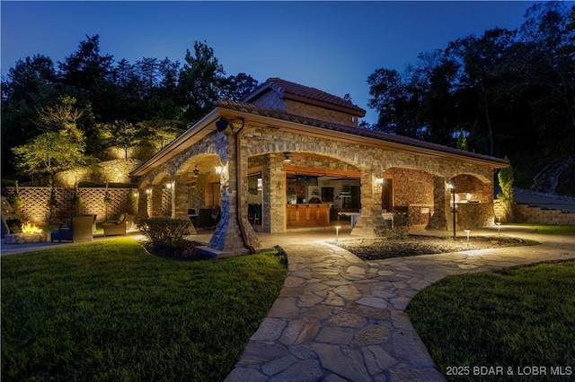 exterior space featuring a patio area and a lawn