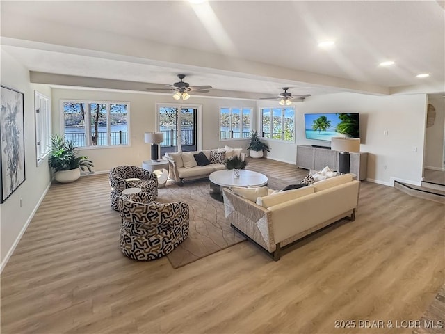 living area with beam ceiling, baseboards, ceiling fan, recessed lighting, and light wood-style flooring
