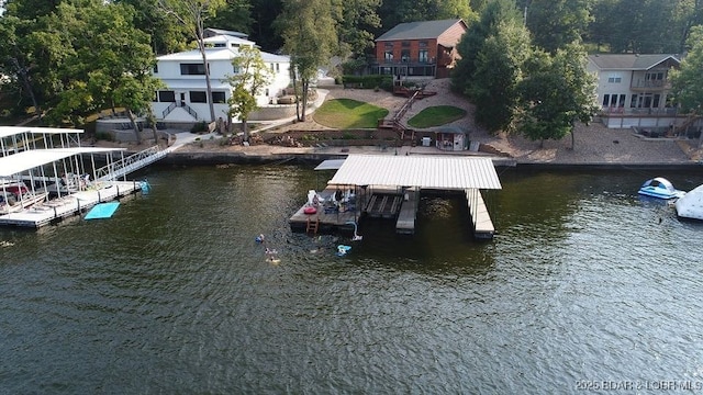 dock area with boat lift, stairway, and a water view