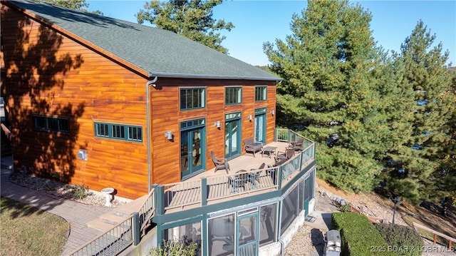 back of house featuring french doors, a balcony, and a shingled roof