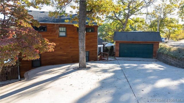 view of side of home with an outdoor structure and a garage