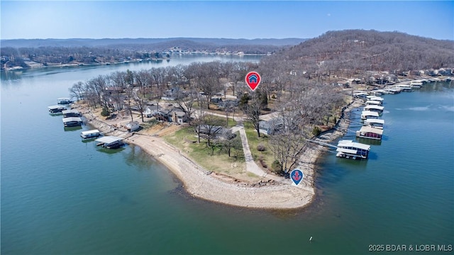 drone / aerial view featuring a water and mountain view