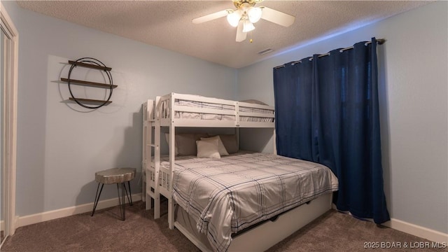 carpeted bedroom with visible vents, baseboards, a textured ceiling, and a ceiling fan