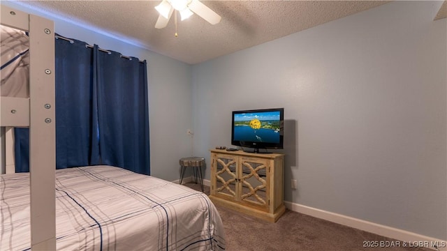 carpeted bedroom with ceiling fan, baseboards, and a textured ceiling