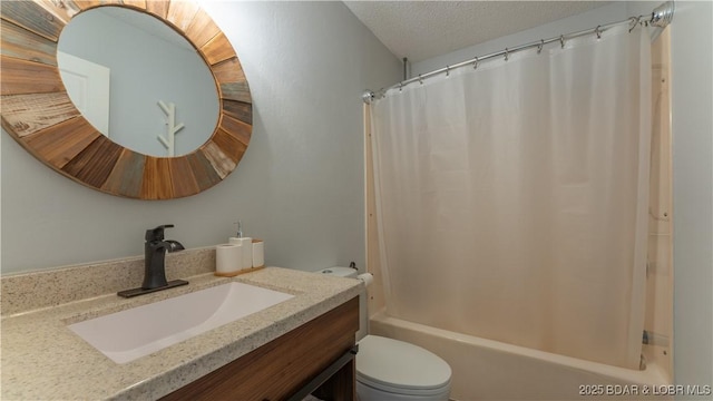 bathroom with vanity, shower / tub combo, toilet, and a textured ceiling