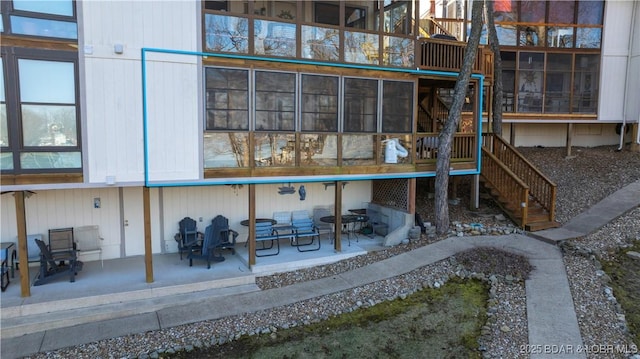 exterior space featuring stairway and a patio area