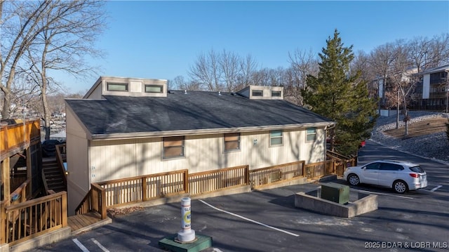 exterior space with roof with shingles