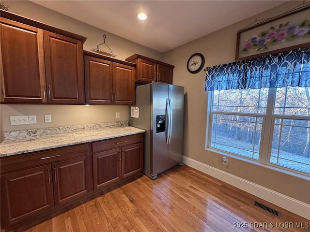 217 Highline Rd, Lake Ozark, MO 65049 - kitchen featuring stainless steel fridge with ice dispenser, recessed lighting, baseboards, light wood-type flooring, and visible vents