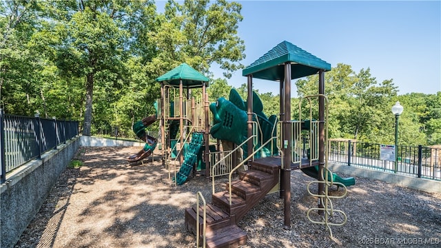 community jungle gym featuring fence