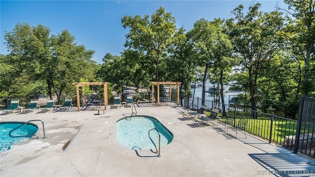 pool featuring a patio area and fence