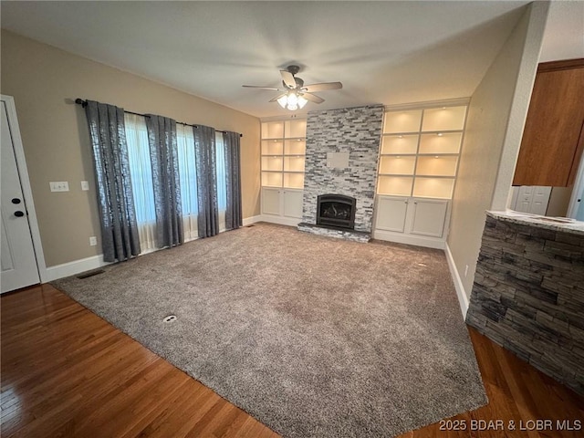 217 Highline Rd, Lake Ozark, MO 65049 - unfurnished living room featuring a ceiling fan, a fireplace, built in features, and wood finished floors