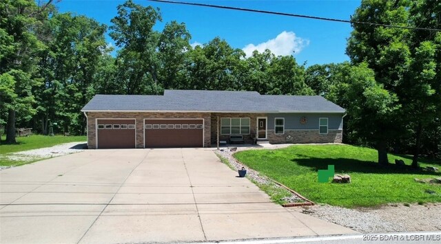 217 Highline Rd, Lake Ozark, MO 65049 - single story home featuring an attached garage, driveway, a front yard, and stone siding