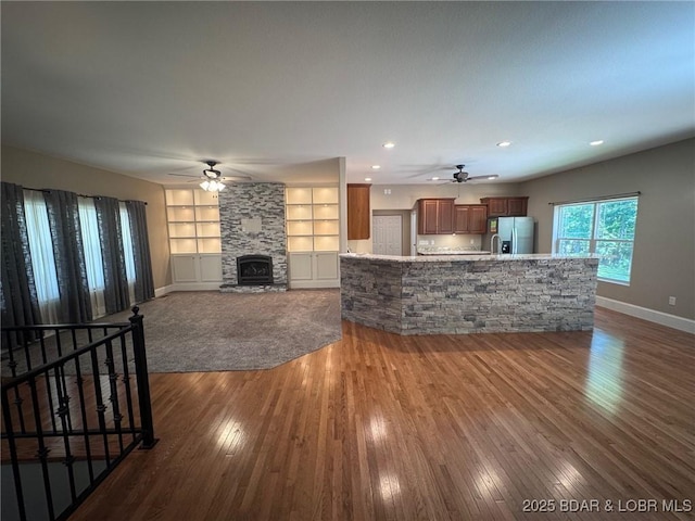 217 Highline Rd, Lake Ozark, MO 65049 - unfurnished living room with a ceiling fan, dark wood-style floors, a stone fireplace, built in features, and recessed lighting