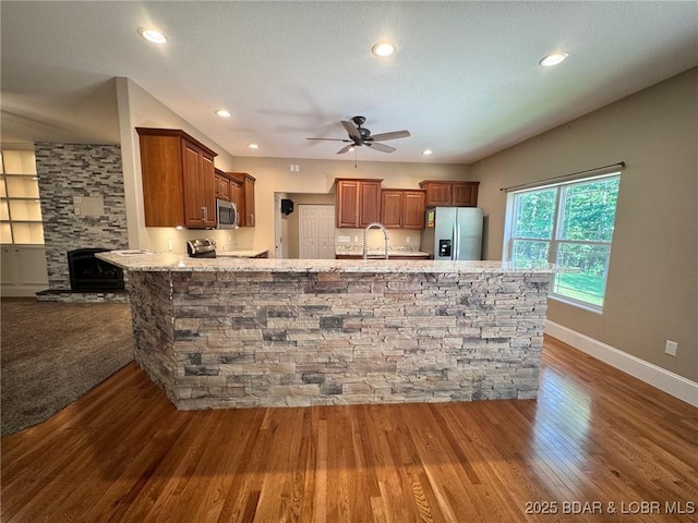 217 Highline Rd, Lake Ozark, MO 65049 - kitchen with appliances with stainless steel finishes, a ceiling fan, dark wood-style flooring, a peninsula, and recessed lighting