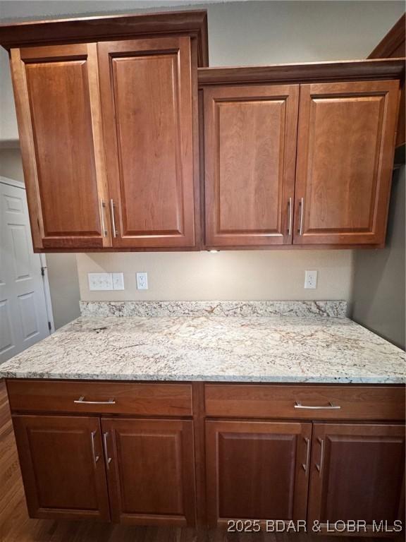 217 Highline Rd, Lake Ozark, MO 65049 - kitchen featuring wood finished floors, light stone counters, and brown cabinets