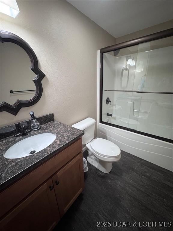 217 Highline Rd, Lake Ozark, MO 65049 - bathroom with vanity, bath / shower combo with glass door, and wood finished floors