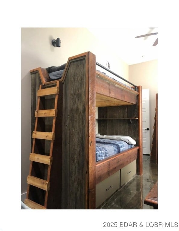 bedroom featuring finished concrete flooring